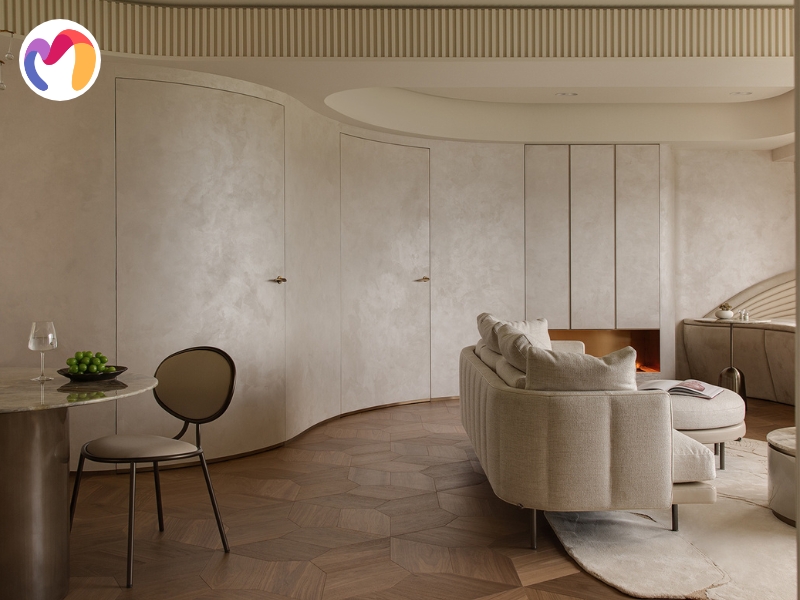 Organic shapes with polished metal hardware steer interiors toward a softer and more approachable mood